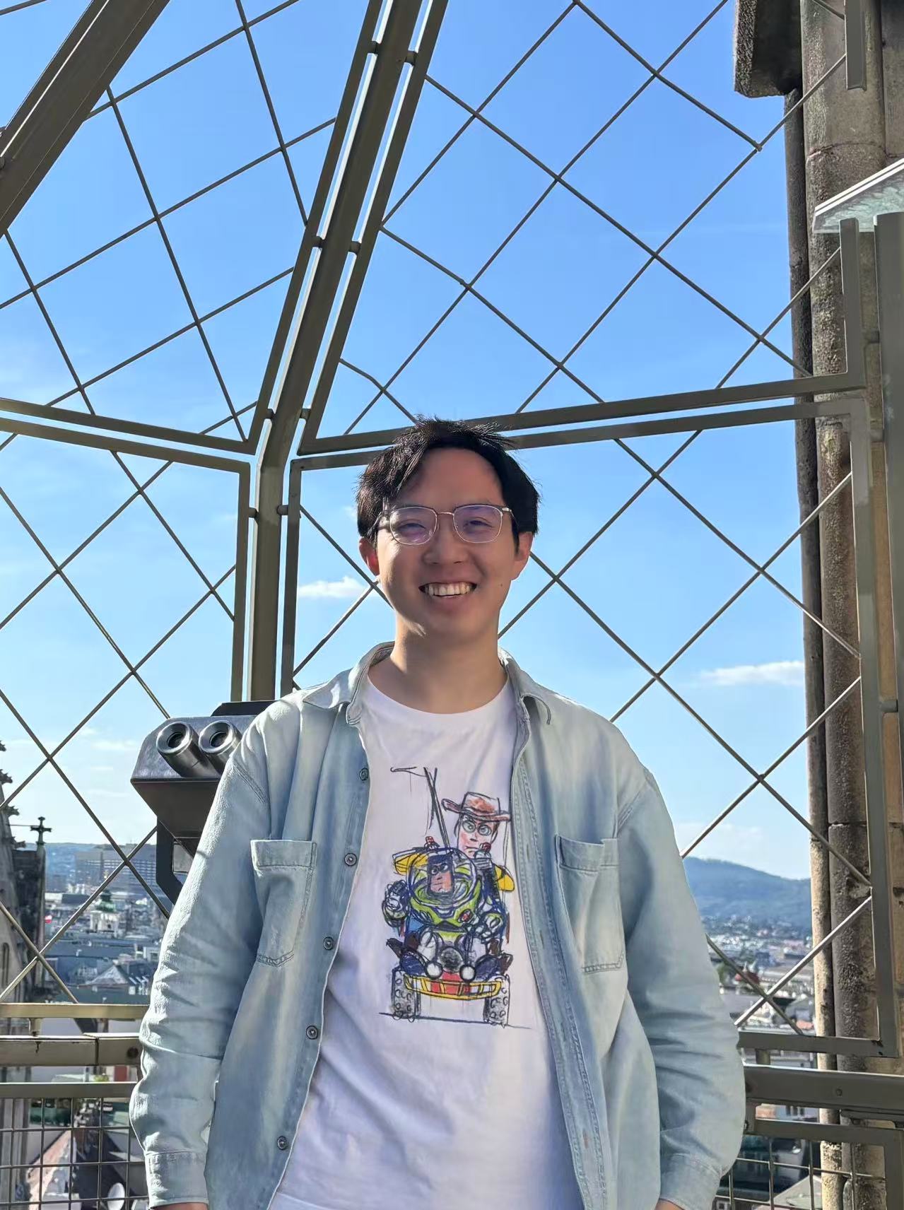 Yuexiao Ma smiling outdoors at a city viewpoint
